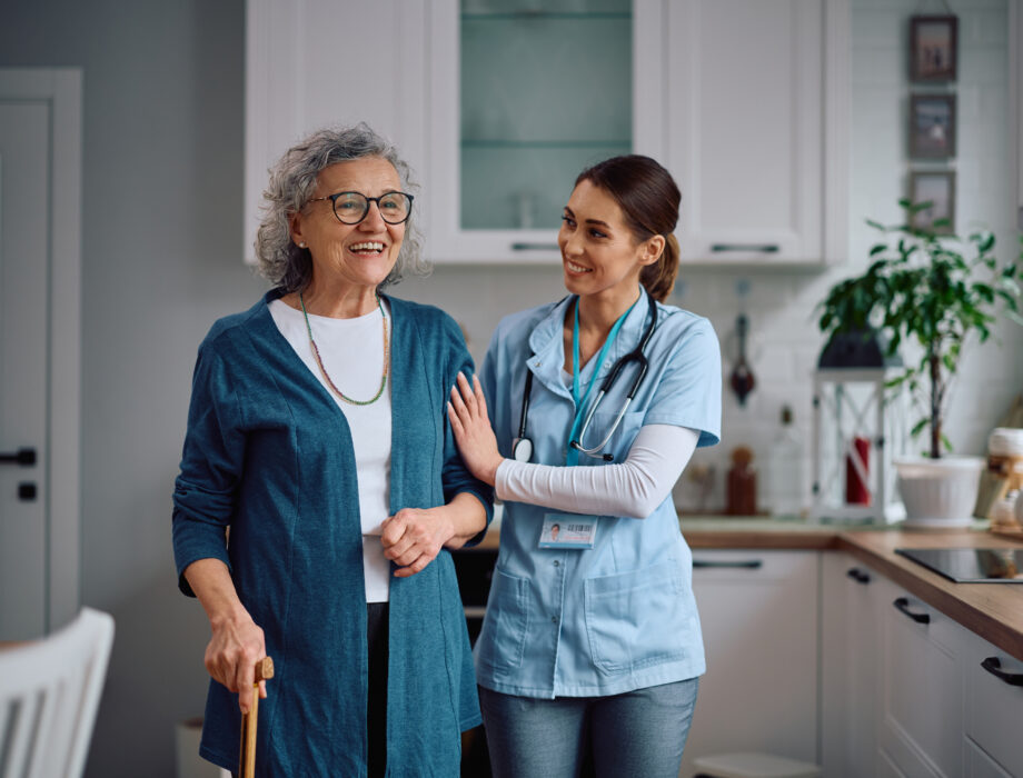 Older woman with a healthcare professional discussing healthy aging at home
